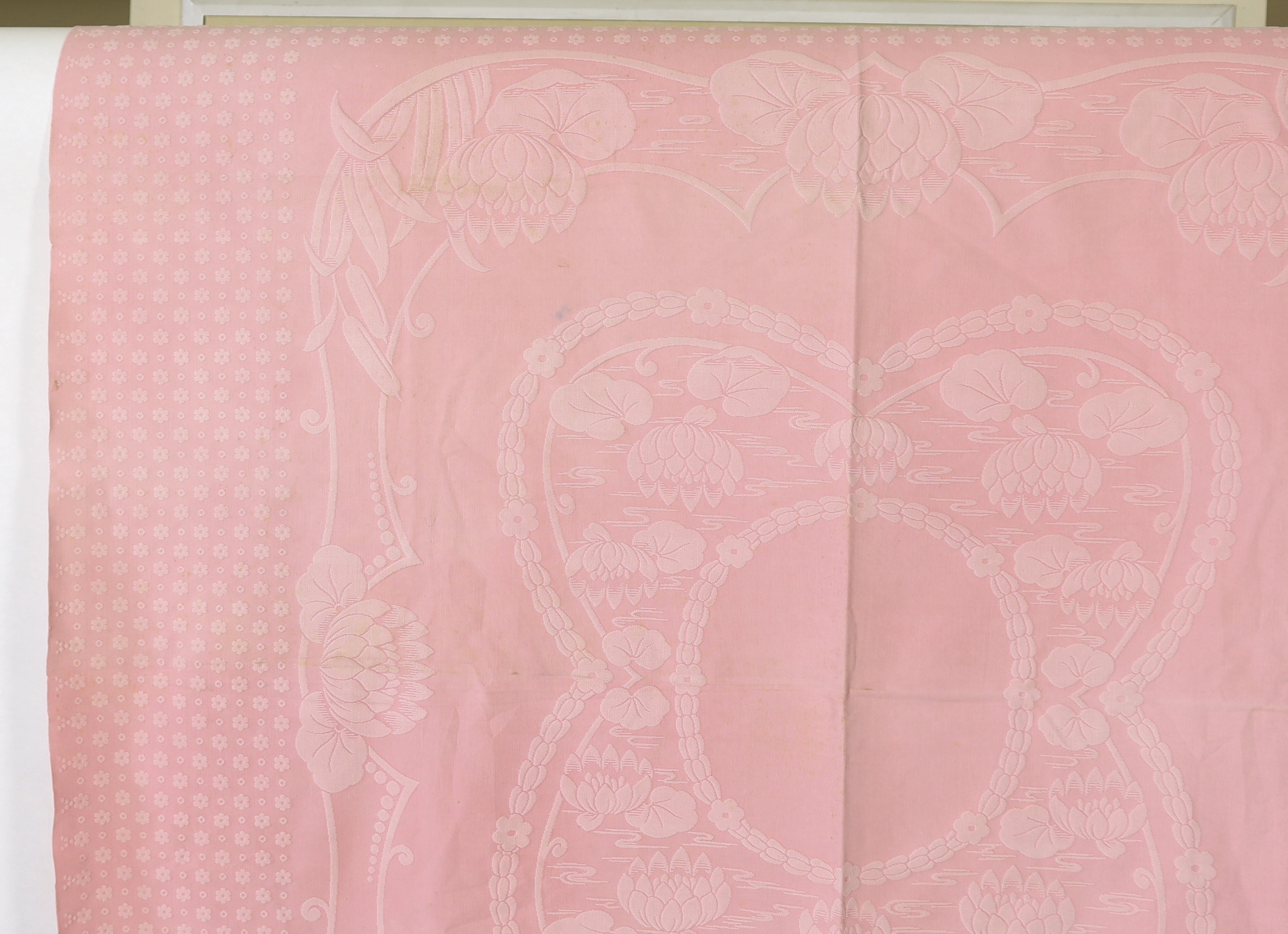 An early 20th century pink lily pad and bull rush designed woven ‘Marcella’ bedspread, 192cm wide, 228cm long